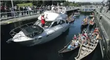  ??  ?? Boats and tribal canoes take part in the Tribal Journey in the Hiram M. Chittenden locks, known locally as the Ballard Locks in Seattle. The Tribal Journey is held every year as a way to preserve Indian heritage.