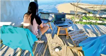  ??  ?? A remote worker taking a ‘workation’ at a co-living and co-working space in the Philippine­s.