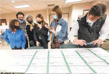  ?? MARYALTAFF­ER/AP ?? Democratic and Republican canvass observers inspect Lehigh County provisiona­l ballots on Nov. 6 as vote counting in the general election continued in Allentown.