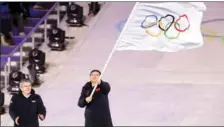  ?? ?? Beijing receives the Olympic flag from South Korea at the closing ceremony of the 2018 Pyeongchan­g Winter Games on Feb 25, 2018.