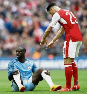  ??  ?? That’s not fair: Arsenal’s Granit Xhaka offering his hands to Manchester City’s Yaya Toure in the English FA Cup semi-final at Wembley on Sunday. — Reuters