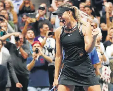  ?? AFP ?? Maria Sharapova celebrates winning her US Open first round match against Simona Halep on Monday. The Russian served a 15month ban for doping before returning early this year.