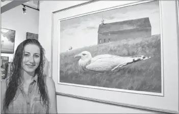  ?? SALLY COLE/THE GUARDIAN ?? Christine Gray, assistant manager, stands next to Gaspé, an acrylic painting by P.E.I. artist Richard Vickerson. It’s one of the pieces in “New Work” at Details Fine Art Gallery in Charlottet­own. The new Vickerson exhibition runs until July 16.