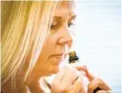  ?? JERRY JACKSON/BALTIMORE SUN ?? Christine Creed sniffs one of several essential oils from a smell retraining kit. Creed has parosmia, experienci­ng a distortion of smell, stemming from a COVID-19 infection in November.