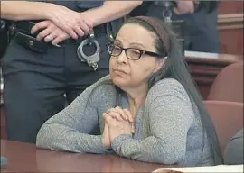 ?? Pool Photo ?? YOSELYN ORTEGA listens in court as her murder trial begins in New York. Prosecutor­s say she stabbed to death a 6-year-old girl and 2-year-old boy in 2012.