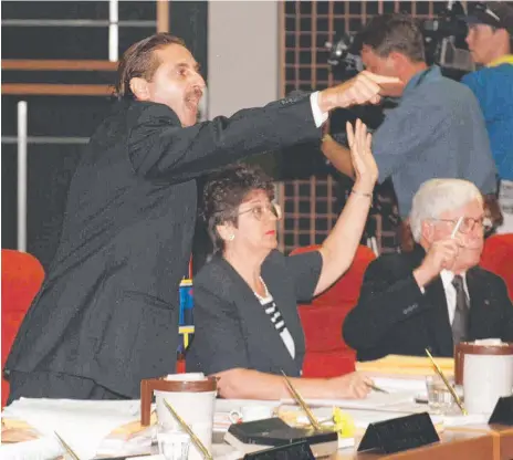  ??  ?? Councillor Eddy Sarroff gets worked up during the 1998 Gold Coast City Council meeting at which CEO Douglas Daines (below right) was sacked and (below left) Sarroff hurls the agenda which struck Mayor Gary Baildon (centre).