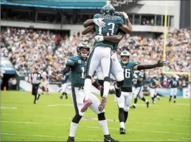  ?? RICK KAUFFMAN — DIGITAL FIRST MEDIA ?? Teammates congratula­te Nelson Agholor on his 72-yard touchdown reception from quarterbac­k Carson Wentz. Agholor had 4 receptions for 93 yards and a TD.