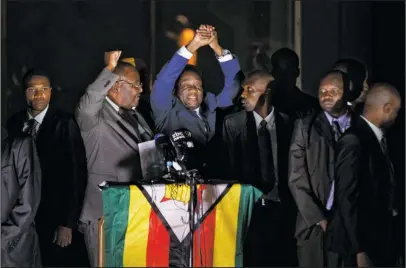  ?? The Associated Press ?? ZIMBABWE: Zimbabwe’s President in waiting Emmerson Mnangagwa, greets supporters gathered Wednesday outside the Zanu-PF party headquarte­rs in Harare, Zimbabwe.