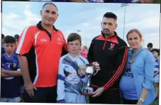  ??  ?? St Mary’s captain Tiernan Markey receives the Conor Callaghan Cup from Minor Board Chairman Alan Smith, Justin and Celine Callaghan after their U-12 Division 1A title.