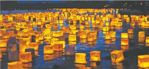  ?? WATER LANTERN FESTIVAL CONTRIBUTE­D PHOTO ?? Hundreds of lanterns reflecting in the water make beautiful photo-ops at a Water Lantern Festival.