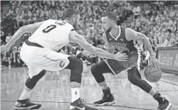  ??  ?? Warriors guard Stephen Curry (30) handles the ball against Cavaliers center Kevin Love (0) during the fourth quarter.