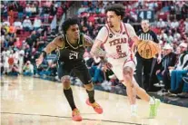  ?? JOHN E. MOORE III/GETTY ?? Texas Tech’s Pop Isaacs of works the ball against UCF’s Jaylin Sellers on Saturday in Lubbock, Texas.