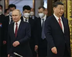  ?? Kremlin Pool Photo via AP ?? Russian President Vladimir Putin, left, and Chinese President Xi Jinping enter a hall for their talks Tuesday at The Grand Kremlin Palace, in Moscow, Russia.