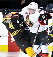  ?? AP/CHARLES KRUPA ?? Ottawa center Jean-Gabriel Pageau (right) drops Boston defenseman Charlie McAvoy to the ice on a hard check during the first period in Game 3 of their NHL Eastern Conference playoff matchup Monday. The Senators got a goal from Bobby Ryan in overtime to...