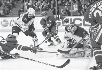  ?? CP PHOTO ?? Boston Bruins defenceman Adam McQuaid battles Toronto Maple Leafs for the puck during Game 6 Monday in Toronto. From left are Nazem Kadri, McQuaid, Tyler Bozak, Bruins goalie Tuukka Rask and James van Riemsdyk.