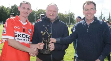  ??  ?? David Murphy receives the Duhallow Junior Hurling Final man of the Match Award from Seamus O’Keeffe and Joe Noonan, Kanturk CoOp Mart. Photo by John Tarrant