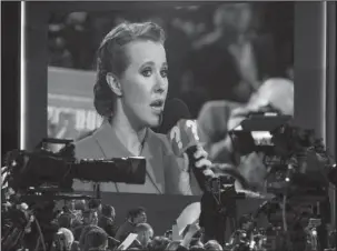  ?? The Associated Press ?? ANNUAL NEWS CONFERENCE: Celebrity TV host Ksenia Sobchak, who wants to challenge Russian President Vladimir Putin in the March 18 presidenti­al election, is seen on a big screen as she asks a question Thursday during Putin’s annual news conference in...