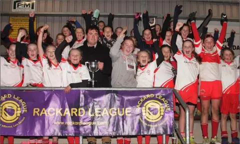  ??  ?? The triumphant Kilanerin squad after Thursday’s final victory as Jim Dempsey presents the cup to Saoirse McDonald and Kiva Kinsella.