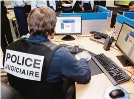  ??  ?? NANTERRE: In this Jan 19, 2015 photo, a French police officer works at the headquarte­rs of the Pharos reporting platform against cyber criminalit­y outside Paris. — AP