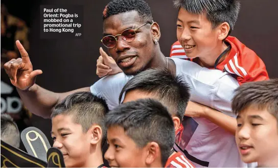  ?? AFP ?? Paul of the Orient: Pogba is mobbed on a promotiona­l trip to Hong Kong