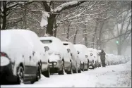  ?? JOHN MINCHILLO — THE ASSOCIATED PRESS ?? A motorist clears his car of snow Feb. 1in the Clinton Hill neighborho­od of the Brooklyn borough of New York.