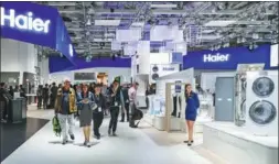  ?? XINHUA ?? Visitors to the internatio­nal appliances expo at Berlin last year walk past Haier’s booth. Haier is set to become the first Chinese company to list its shares on the Frankfurt, Germany-based CEIE.