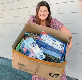  ??  ?? Justine Shera with some of the presents donated to children’s charity Gabby’s Starlit Hope by Glenn and Kate Demchy, owners of New Plymouth Toyworld.