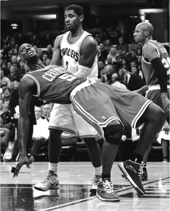  ??  ?? Boston Celtics' Kevin Garnett (5) watches his shot as he falls backwards after being fouled in the first half of an NBA basketball game against the Cleveland Cavaliers in Cleveland. Behind Garnett is Cleveland Cavaliers' Kyrie Irving. ASSOCIATED PRESS