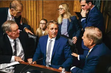  ?? DAMON WINTER / THE NEW YORK TIMES ?? Sen. Jeff Flake, R-Ariz. (center), confers Friday with Sen. Mike Crapo, R-Idaho (seated at left), Sen. Thom Tillis, R-N.C., (standing at left), and Sen. Lindsey Graham, R-S.C. (seated at right).