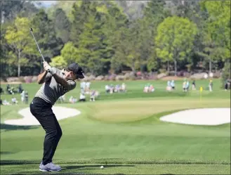  ?? Gregory Bull / Associated Press ?? Rory Mcilroy, of Northern Ireland, tees off on the fourth hole during a practice round for the Masters on Wednesday. He remarked on the firm greens.