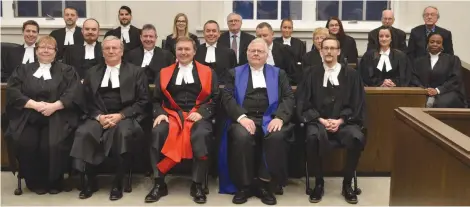  ??  ?? Lorna Cottenden, front left, and Jared McRorie, front right, were called to the bar during their Bar Admission Ceremony Thursday at the Court of Queen’s Bench in Moose Jaw. They are pictured with Chief Justice Robert G. Richards, second from front left, Justice Darin Chow, Judge Brian Hendrickso­n and other members of Moose Jaw’s legal community behind them. Matthew Gourlie photograph