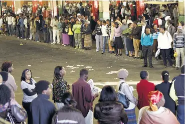  ?? /Antonio Muchave/Sowetan ?? Hurry up and wait: Weary commuters wait in long queues at downtown Johannesbu­rg’s Bree Street taxi rank. The taxi industry is taking measures to limit the spread of the coronaviru­s.