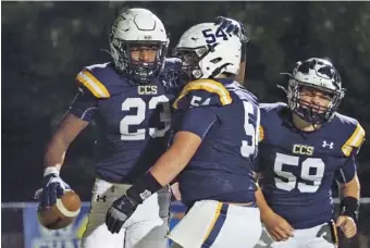  ?? STAFF PHOTO BY C. B. SCHMELTER ?? Chattanoog­a Christian’s Javoris Havis (23) celebrates with teammate William Wall after scoring a touchdown during Friday night’s 48-21 home win against Silverdale Baptist Academy to close the regular season.