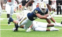  ?? STAFF PHOTO BY MATT HAMILTON ?? UTC’s Lance Jackson dives for extra yards during the first half of Saturday’s game against Mercer.