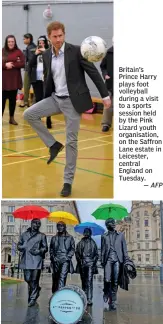  ?? — AFP — AP ?? Britain’s Prince Harry plays foot volleyball during a visit to a sports session held by the Pink Lizard youth organisati­on, on the Saffron Lane estate in Leicester, central England on Tuesday. Umbrellas are placed over the statute of the Beatles,...