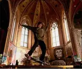  ?? Christian Gooden / TNS ?? Skateboard­er Evan Stovall, of Oakville, Mo., tricks across a flat rail in the former St. Liborius Church in St. Louis' Old North neighborho­od.