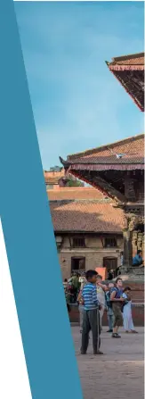  ?? A group of people ride motorcycle­s through Patan Durbar Square, Kathmandu, Nepal. ??