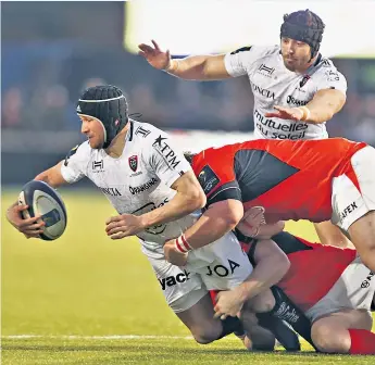  ??  ?? French flair: Toulon’s Matt Giteau is tackled by two Saracens forwards