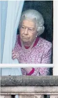  ??  ?? The Queen draws aside the palace net curtains last year