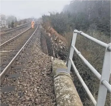  ??  ?? 0 Damage to the bridge was spotted today a mile north of the site of last year’s fatal landslide