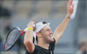  ?? MICHEL EULER — THE ASSOCIATED PRESS ?? Argentina’s Diego Schwartzma­n celebrates winning his quarterfin­al match of the French Open against Austria’s Dominic Thiem in five sets at the Roland Garros stadium in Paris, France on Tuesday.