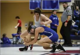  ?? DIGITAL FIRST MEDIA FILE ?? Exeter Township’s Tyler Harkness, bottom, got a late takedown and won in overtime for a pivotal decision in the final of the District 3-AAA Team Duals Championsh­ips against Cedar Cliff on Saturday.