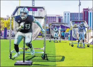  ?? L.E. Baskow Las Vegas Review-journal @Left_eye_images ?? Cutouts of Raiders players Maxx Crosby, Nate Hobbs and Tre’von Moehrig from April’s NFL Draft Experience. Despite a notation error on this week’s OTA roster, Hobbs is still playing cornerback.