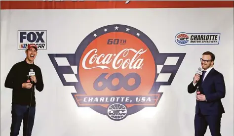  ?? Chuck Burton / Associated Press ?? Joey Logano, left, laughs with Marcus Smith, right, president and chief operating officer and director of Speedway Motorsport­s, Inc., during a news conference at Charlotte Motor Speedway in Concord, N.C., in 2019.