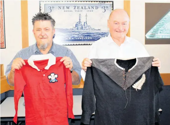  ?? ?? Mowbray Collectabl­es' Brendan Watson (left) and John Mowbray, with a Welsh and All Blacks jersey from 1905.