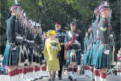  ?? Pictures: TIM ROOKE/REX, PA ?? The Queen inspects the guard of honour during Holyroodho­use’s ancient Ceremony of the Keys yesterday