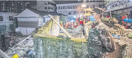  ?? ?? LAST LUNCH: Rescuers search at the scene of an explosion that caused a building housing a canteen to collapse in southweste­rn China’s Chongqing around noon on Friday.