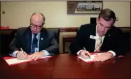  ?? CONTRIBUTE­D PHOTO ?? Pete McDonald (left), president of GNTC, and Dr. Mike Holmes (right), senior vice president, chief academic officer, and dean of faculty at GMC sign an articulati­on agreement at GNTC’s Floyd County Campus in Rome.