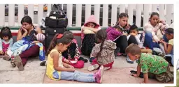  ??  ?? Waiting: Migrants, many of them children, on the border between the US and Mexico