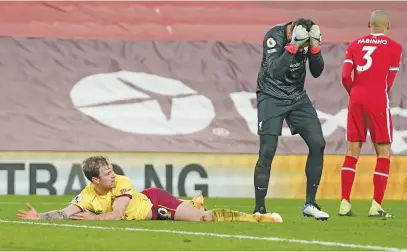  ?? Picture: AFP ?? CRINGING. Liverpool goalkeeper Alisson Becker looks gutted after fouling Burnley’s Ashley Barnes to concede a penalty which lead to their 1-0 loss in the English Premier League at Anfield on Thursday night.
